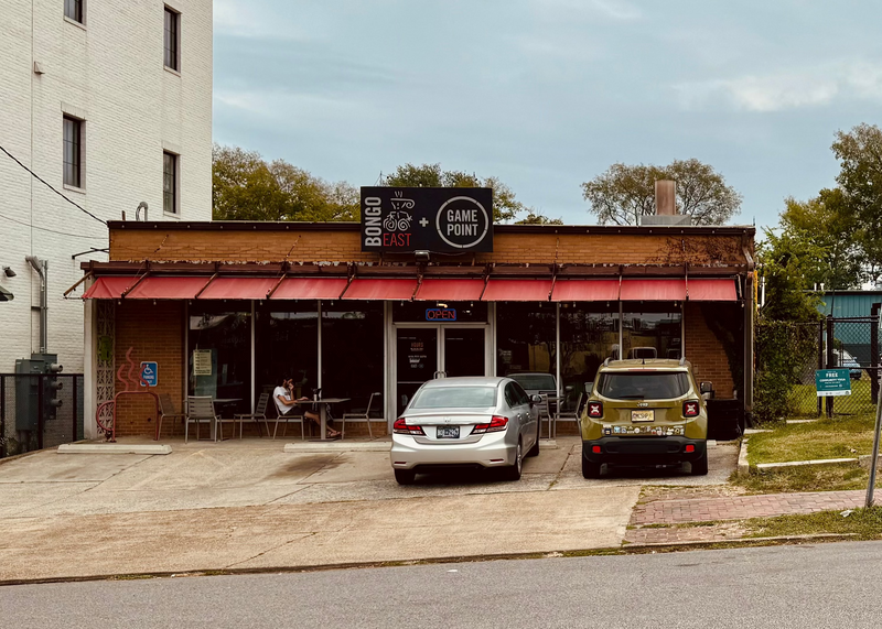 Bongo East in 5 Points, Nashville, TN. Small business with red awning and parked cars on a street corner