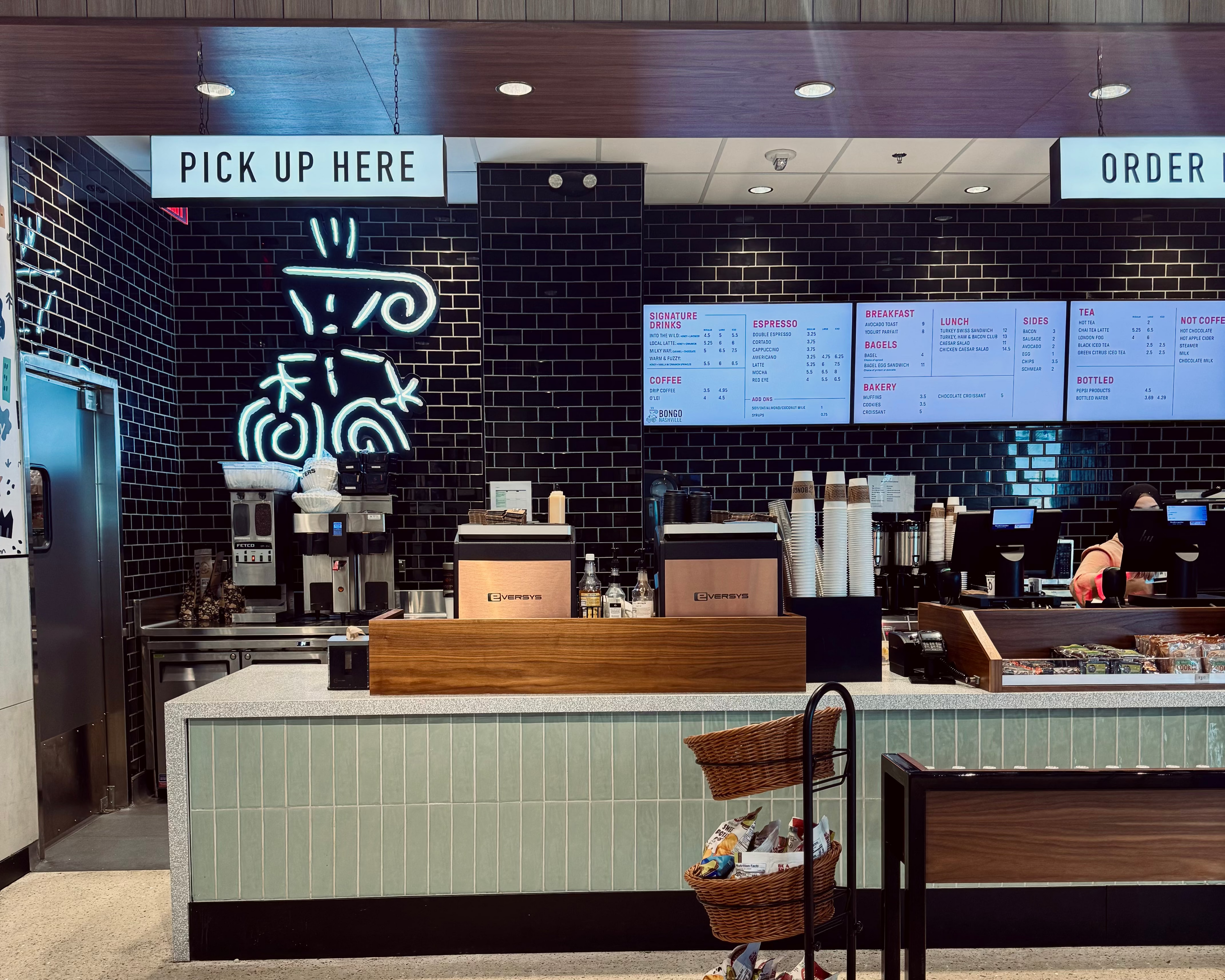 Bongo Java cafe at BNA, Nashville Airport store interior with counter and digital menu boards.